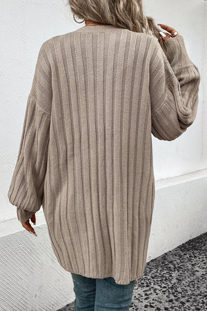 Khaki ribbed acrylic longline cardigan with balloon sleeves.
