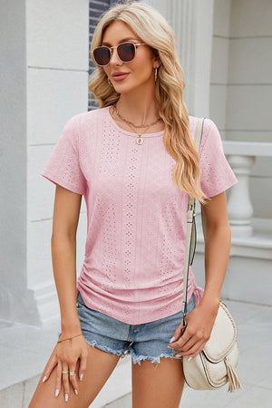 Blush pink perforated tee with gathered sides and short sleeves.
