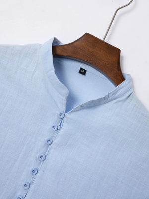 Light blue linen henley polo shirt with button placket and mandarin collar.