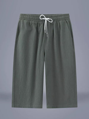 Relaxed cropped sweatpants in Army Green with drawstring waist and pockets.