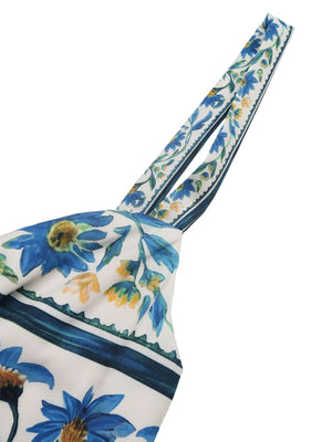 Maxi dress with blue floral print and twisted detail straps.