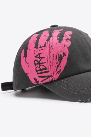 Dark gray baseball cap with distressed edges and a pink graffiti hand print with VIBRA text.