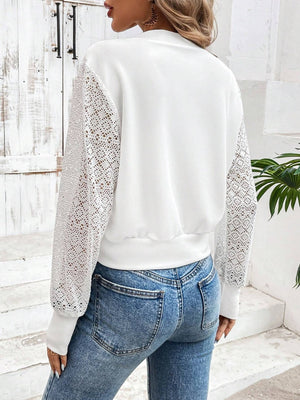 White bomber jacket with lace sleeves and ribbed cuffs and hem.