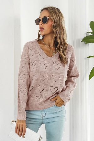 Dusty pink acrylic v-neck sweater with allover heart stitch pattern and long sleeves.