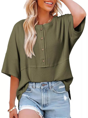 Green waffle-knit t-shirt with button detail and textured hem.