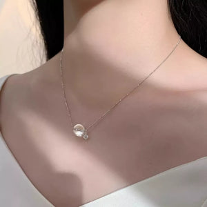 Luminous crystal pendant necklace in silver with delicate chain and cubic zirconia accent.