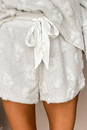 Textured cloud lounge shorts in white with adjustable satin tie and fuzzy floral pattern.