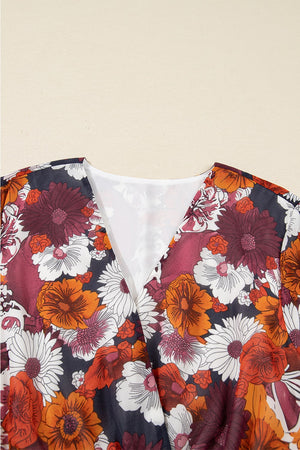 Floral wrap mini dress with V-neck and puff sleeves in a multicolor floral print.