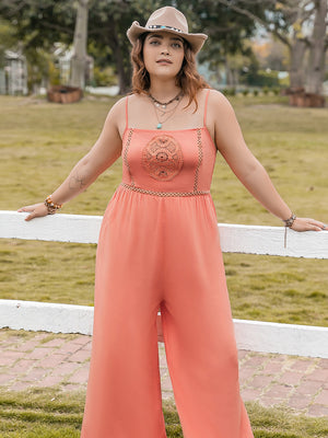 Orange wide leg jumpsuit with embroidered bodice and chain trim detail.