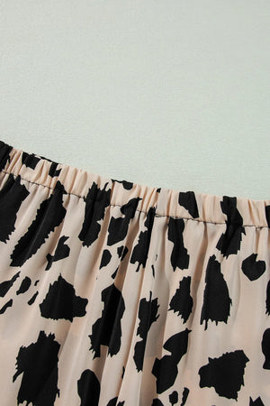 Animal print satin pajama set with elastic waistband and leopard pattern.