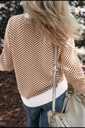 Chevron knit crewneck sweater in camel and white with a white ribbed hem.