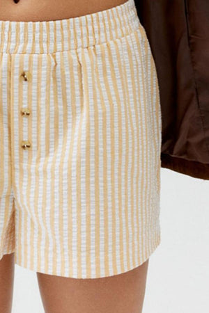 Seersucker boxer shorts in pastel yellow and white stripe with button detail.