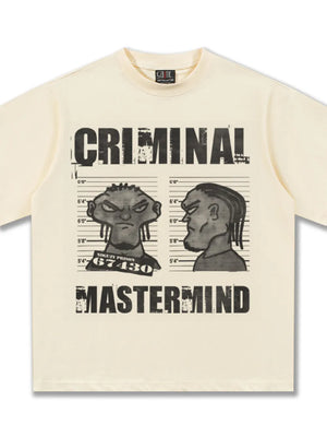 Pastel yellow cotton t-shirt with a bold cartoon graphic of two mugshot portraits and the text Criminal Mastermind.