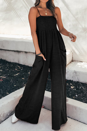 Black smocked bodice palazzo jumpsuit with spaghetti straps and wide legs.