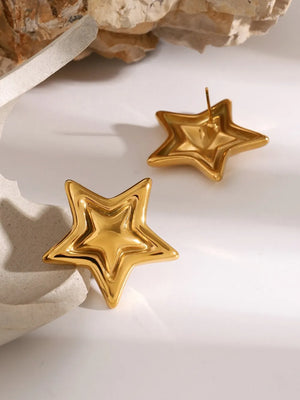 Gold starburst stud earrings with a sculpted, layered design.