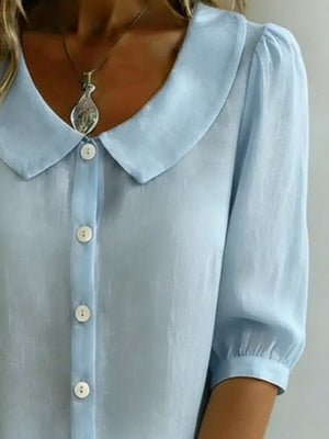 Light blue button-down shirt with puff sleeves and Peter Pan collar