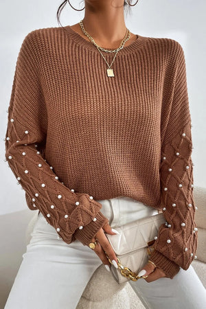 Brown cable knit sweater with pearl embellishments on sleeves, crew neck, long sleeves.