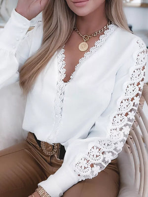 White lace-trimmed V-neck blouse with button cuffs and sheer lace sleeves.