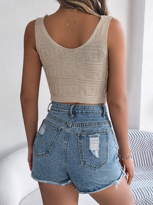 Khaki knit crop top with textured pattern and scoop neck, paired with distressed denim shorts.