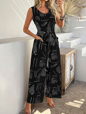 Black abstract print wide-leg jumpsuit with tie waist and pockets.