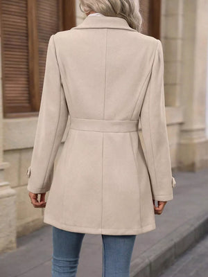 Camel button-up trench coat with cinched waist and buttoned cuffs.