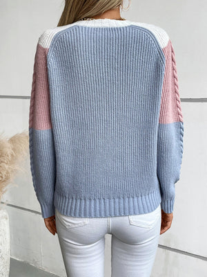 Chevron cable knit sweater in pastel blue, blush pink, and white with braided sleeve detail.