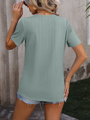 Sage green textured tee with short sleeves and split hem detail.