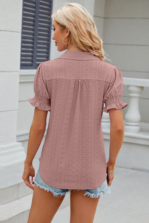 Blush pink eyelet polo blouse with short ruffled sleeves and a collared neckline.