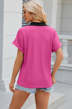 Hot Pink perforated panel polo top with black collar and cuffed short sleeves.