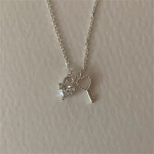 Sterling silver necklace with heart lock charm and key charm