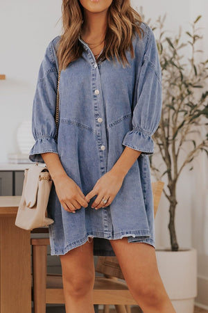 Light blue denim shirtdress with ruffled cuff detail and button front, A-line cut.