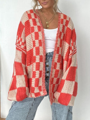 Oversized checkerboard knit cardigan in deep red and beige with balloon sleeves.