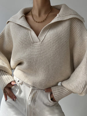 Wide collar balloon sleeve knit sweater in white with a v-neck and ribbed texture.