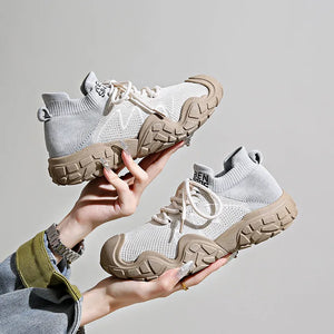 Sculpted knit athleisure sneakers in light beige with chunky tan soles and white laces.