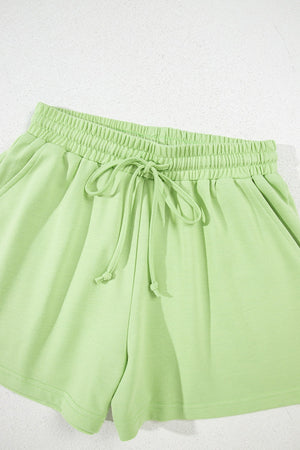Lime cotton lounge shorts with elastic waistband and drawstring.