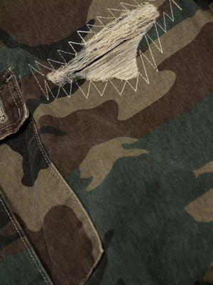 Distressed camouflage cargo pants with visible white zig-zag stitching and frayed details.