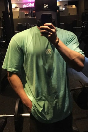 Oversized green t-shirt with white logo detail on chest, short sleeves, crew neck.