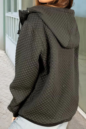 Black quilted zip-through hoodie with drawstring hood and long sleeves.