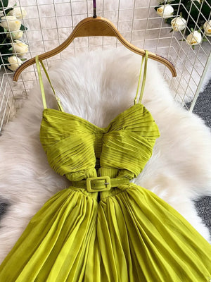 Light Green pleated midi dress with spaghetti straps and a matching belt.