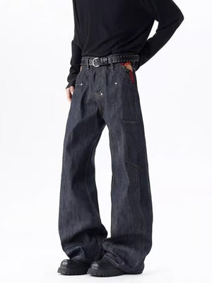 Men's dark wash wide-leg jeans with patterned pocket detail and utility pockets.