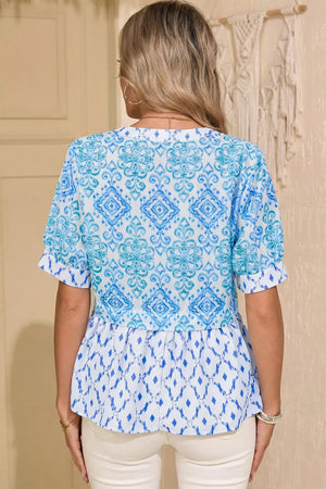 Patchwork babydoll maternity overshirt with puff sleeves in blue and white ikat print.