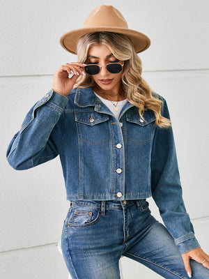 Cropped denim trucker jacket in Dusty Blue with button front and chest pockets.