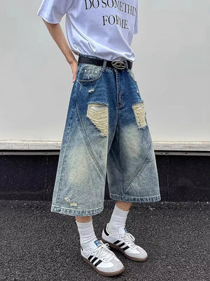 Distressed wide-leg denim shorts in blue with ripped details and a relaxed fit.