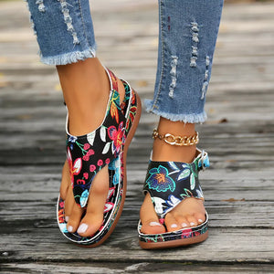 Embroidered floral thong wedge sandals with adjustable ankle straps and a comfortable fit.
