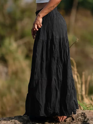Black tiered maxi skirt with a flowing, bohemian cut and crinkled texture.