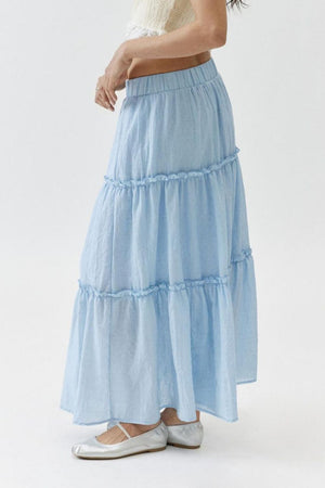 Tiered cotton maxi skirt in light blue with ruffled tiers.