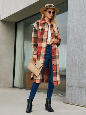Oversized plaid shirt jacket dress in orange-red with button front and chest pockets.
