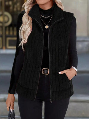 Black fleece zip-up vest with pockets and a stand-up collar.