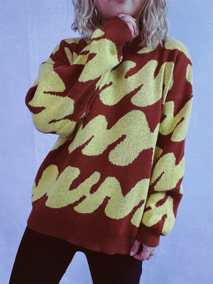 Graphic Wave Knit Sweater in Ochre and Dark Brown with crew neck and long sleeves.