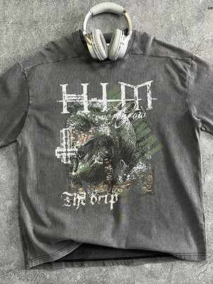 Acid wash graphic t-shirt in dark gray with a distressed monster graphic and text that reads "The Drip".